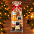 Klaussack mit 60 g Bruchschokolade von der Genussbäckerei Lichtensteiger, Stolli Premium-Nüssen und Biotta Mango Mix – Weihnachtsgeschenk für Mitarbeitende und Kunden von André Probst, Andre’s Superfood.